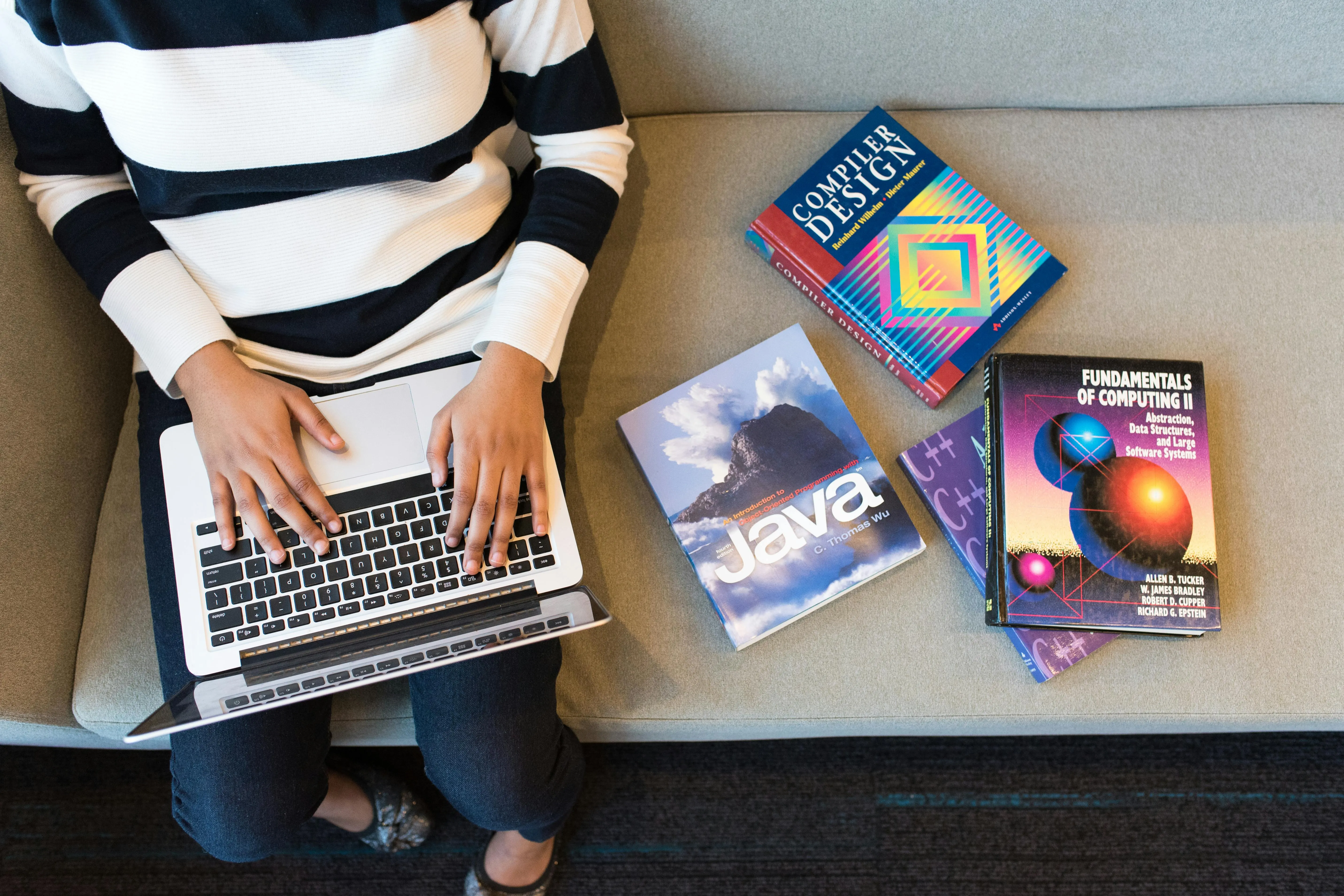 Professional Competencies Development A professional focuses on an online development course on their laptop, with charts and diagrams on screen, symbolizing skills growth.