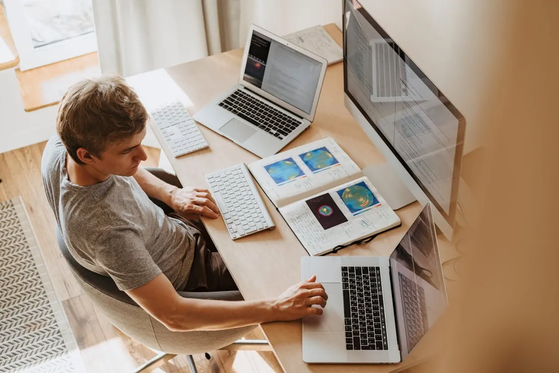 Successful Virtual Technical Interview A person participating in an online job interview from home, speaking confidently in front of their laptop.