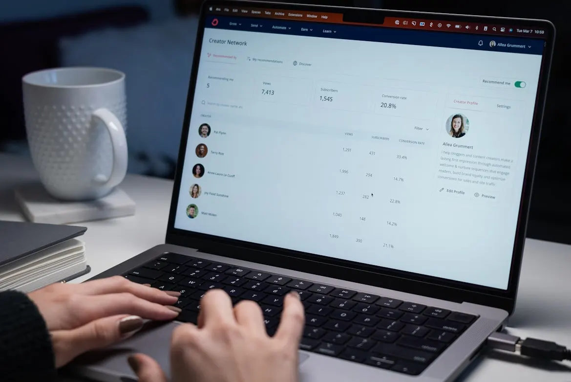 A recruiter analyzes a candidate tracking system dashboard on their computer.